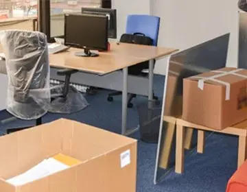 Room being cleared out with furniture covered for renovation