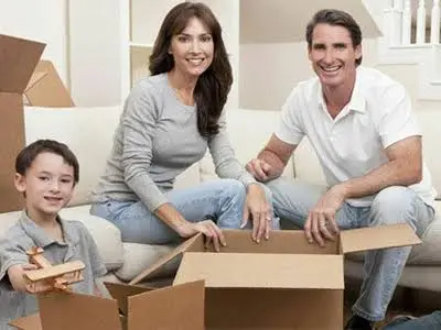 Family unpacking boxes after a move